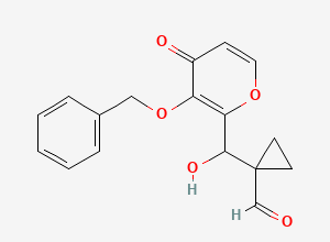 Two-dimensional chemical structure of 1-((3-(Benzyloxy)-4-oxo-4H-pyran-2-yl)(hydroxy)methyl)cyclopropane-1-carbaldehyde