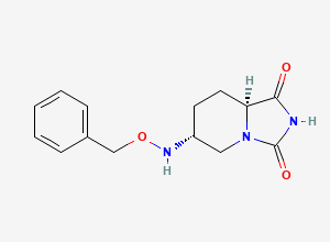 Two-dimensional chemical structure of (6R,8aS)-6-((benzyloxy)amino)tetrahydroimidazo[1,5-a]pyridine-1,3(2H,5H)-dione